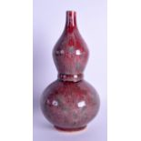 A CHINESE FLAMBE GLAZED DOUBLE GOURD VASE 20th Century, with drip glaze decoration. 20 cm high.