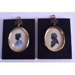 A PAIR OF 19TH CENTURY FRAMED SILHOUETTES depicting a male and female portrait. Image 5 cm x 7 cm.