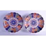 A LARGE PAIR OF 19TH CENTURY JAPANESE MEIJI PERIOD IMARI CHARGERS painted with flowers and motifs.