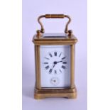 AN ANTIQUE MINIATURE FRENCH BRASS CARRIAGE CLOCK with painted enamel dial and black numerals. 10.