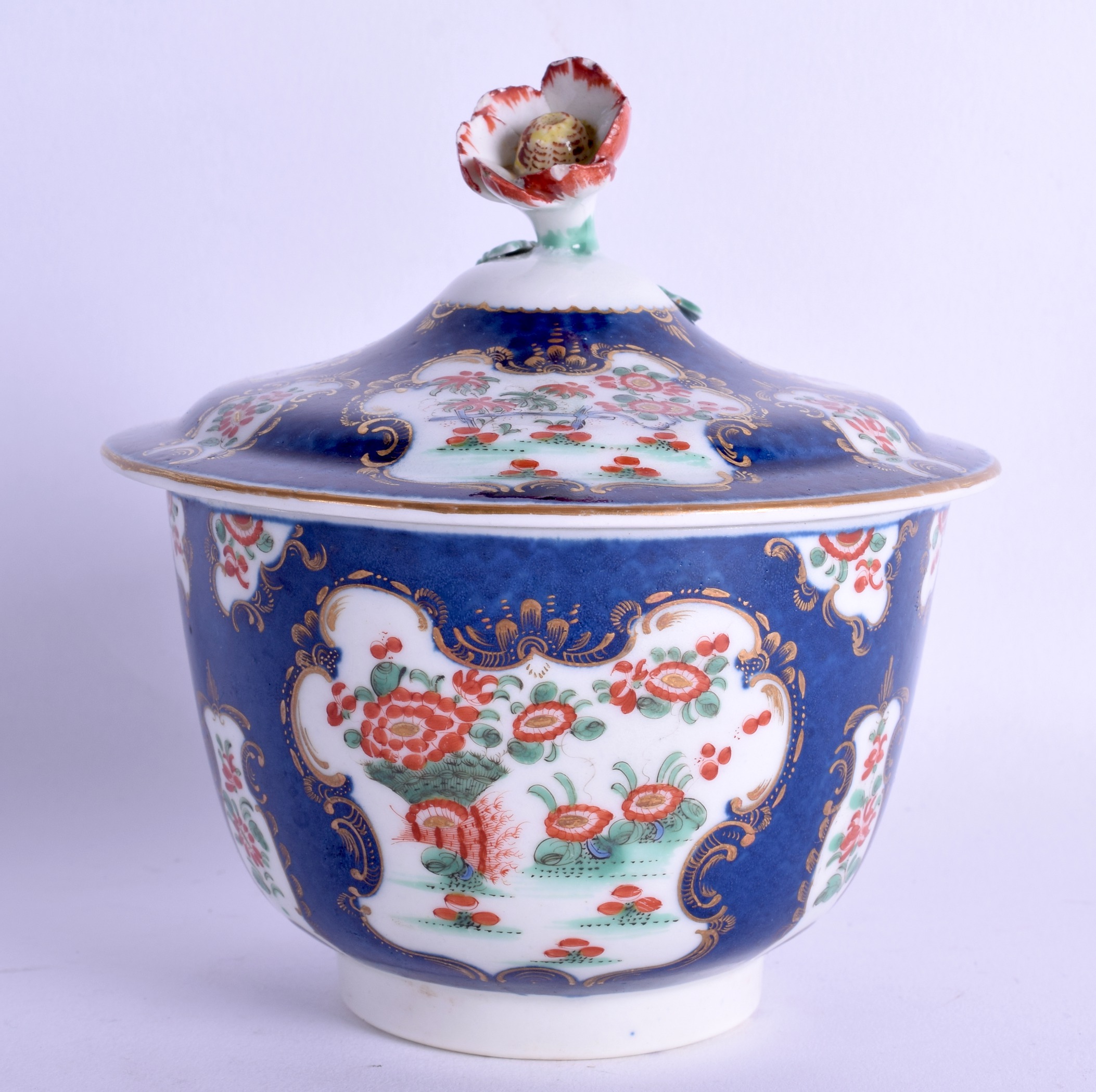 18th c. Worcester sugar bowl and cover painted with kakiemon style flowers on a blue scale ground,