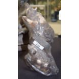 AN UNUSUAL VINTAGE CARVED FLINT FIGURE OF TWO BEARS modelled upon a naturalistic stump. 24 cm high.