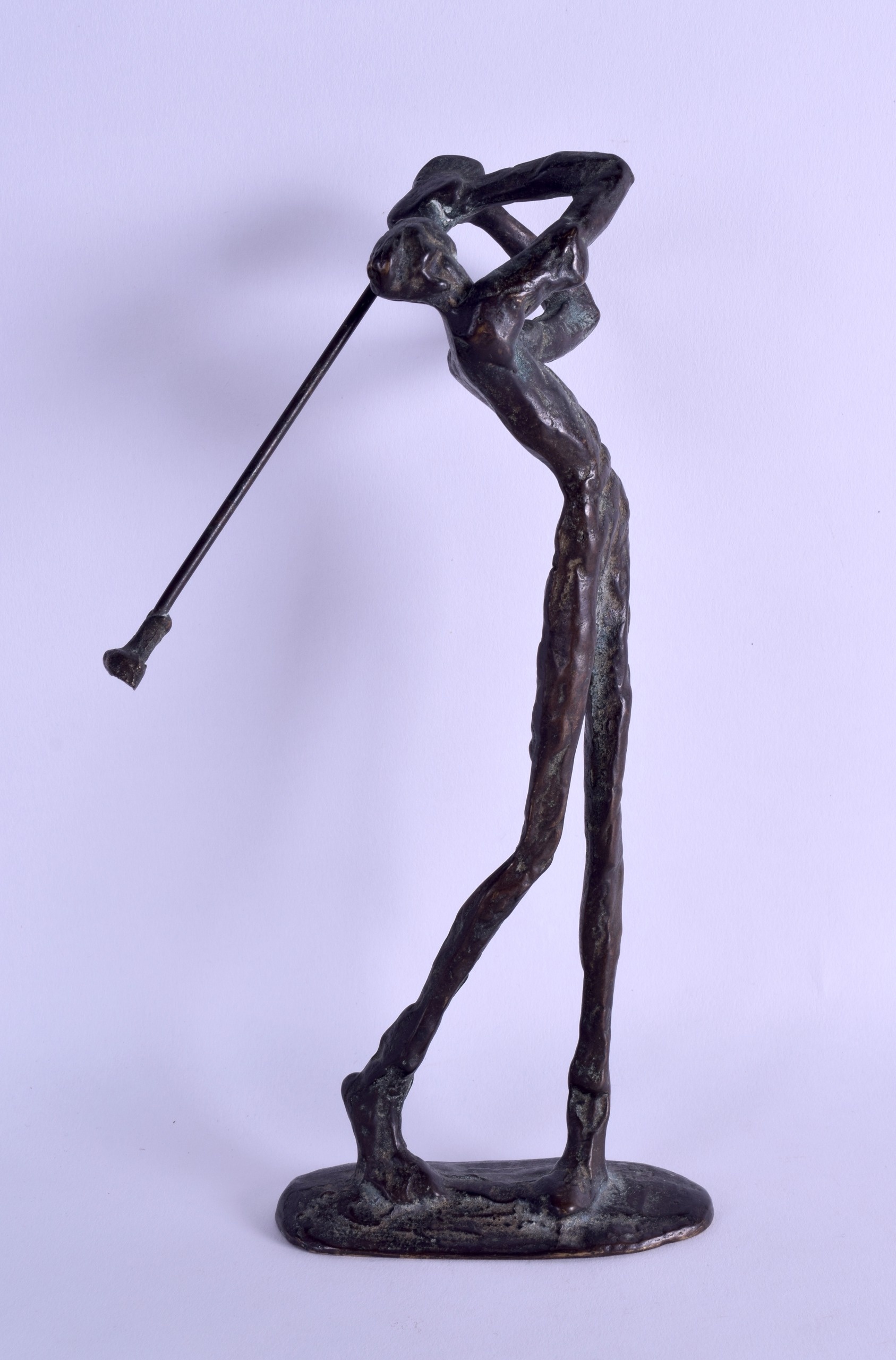 AN ABSTRACT BRONZE FIGURE OF A STANDING GOLFER of stylised form, upon an oval base. 24 cm high.