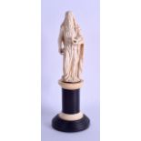 A GOOD 18TH CENTURY EUROPEAN CARVED IVORY FIGURE OF A SAINT possibly representing Saint Anne, upon