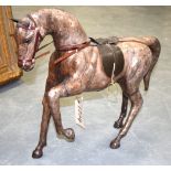 A VINTAGE LEATHER MODEL OF A HORSE. 49 cm wide.