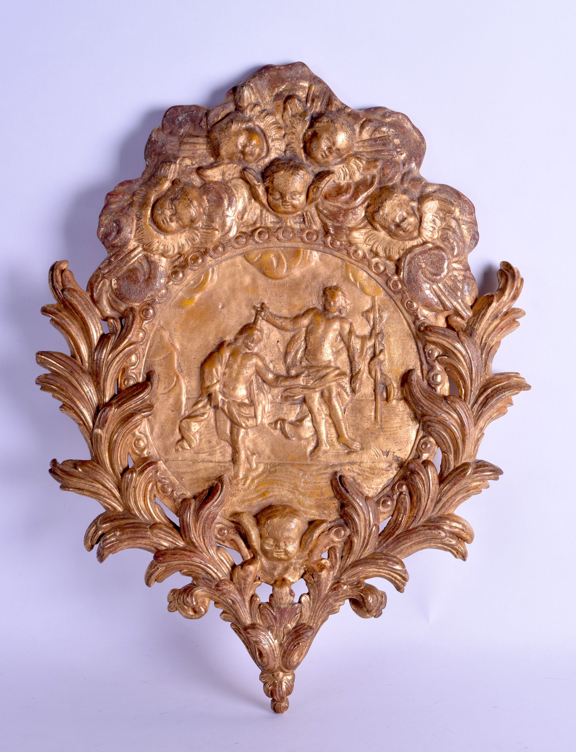 AN 18TH CENTURY CONTINENTAL GILTWOOD RELIGIOUS BAPTISM PLAQUE depicting numerous figures and mask