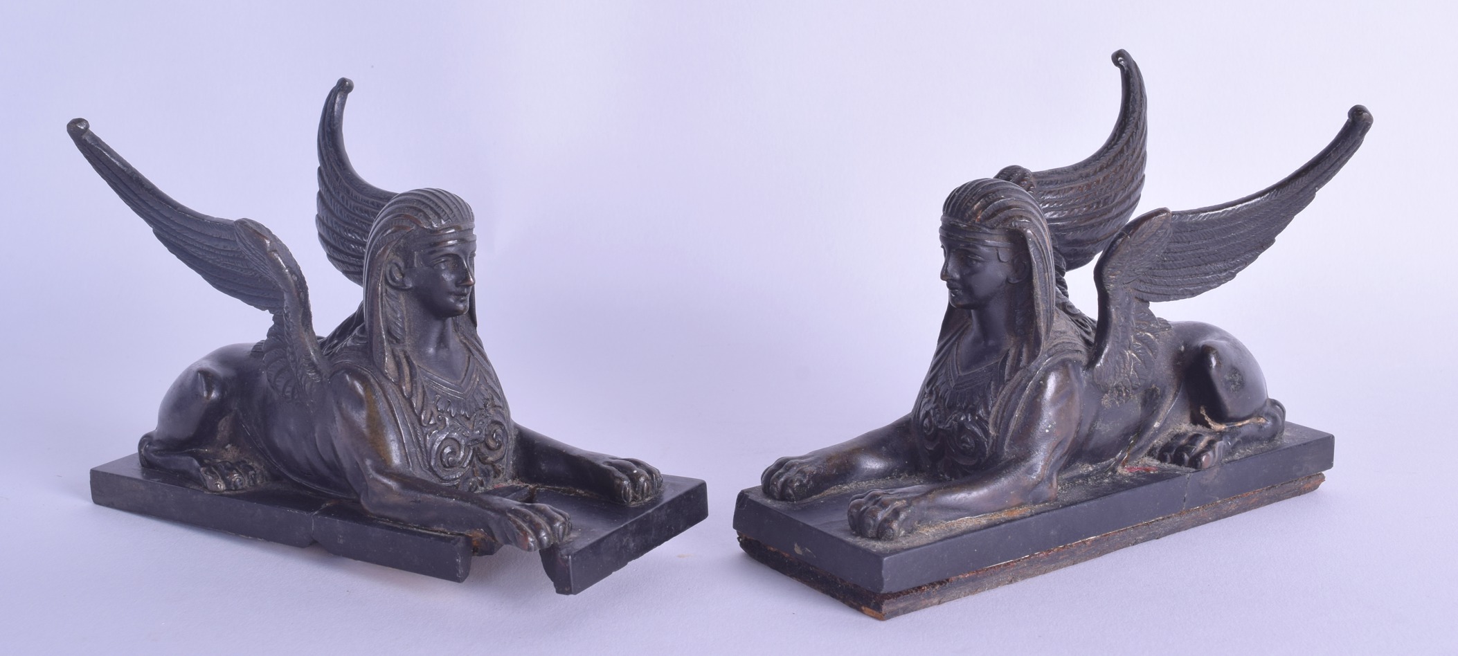 A PAIR OF 19TH CENTURY ITALIAN GRAND TOUR BRONZE FIGURES OF SPHINXES modelled upon black marble