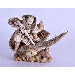 A 19TH CENTURY JAPANESE MEIJI PERIOD CARVED IVORY OKIMONO modelled as a male battling with a