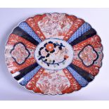 A 19TH CENTURY JAPANESE MEIJI PERIOD IMARI SCALLOPED DISH painted with buddhistic lions and flowers.