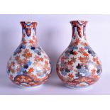 A PAIR OF 18TH/19TH CENTURY JAPANESE EDO PERIOD IMARI VASES painted with floral sprays and motifs.