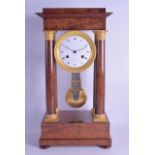AN EARLY 19TH CENTURY FRENCH WALNUT EMPIRE MANTEL CLOCK by Coquet A Paris, with engraved brass
