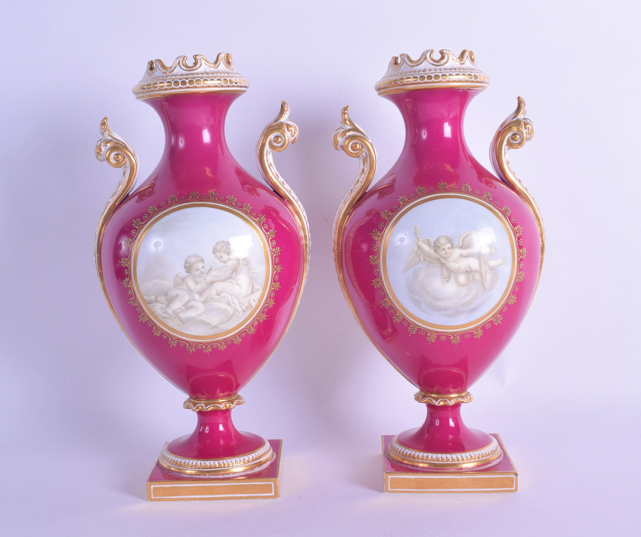 Mid 19th c. Coalport pair of vases painted en-grisaille with cherubs in Watteau style on a crimson