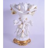 A 19TH CENTURY MOORES PORCELAIN CENTREPIECE modelled as two putti holding floral sprigs. 33 cm