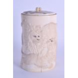 A 19TH CENTURY JAPANESE MEIJI PERIOD CARVED IVORY TUSK VASE AND COVER decorated with lions in