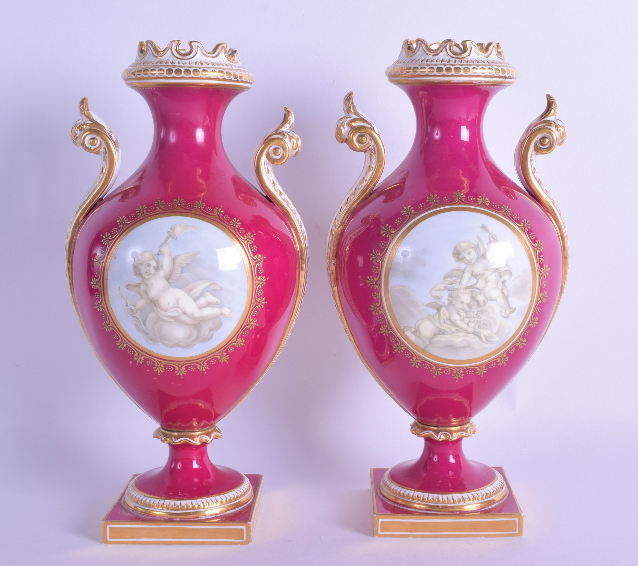 Mid 19th c. Coalport pair of vases painted en-grisaille with cherubs in Watteau style on a crimson - Image 2 of 3