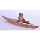 AN UNUSUAL CANADIAN NORTH AMERICAN UNUIT WOOD FIGURE OF A CANOE modelled with a seal hunter