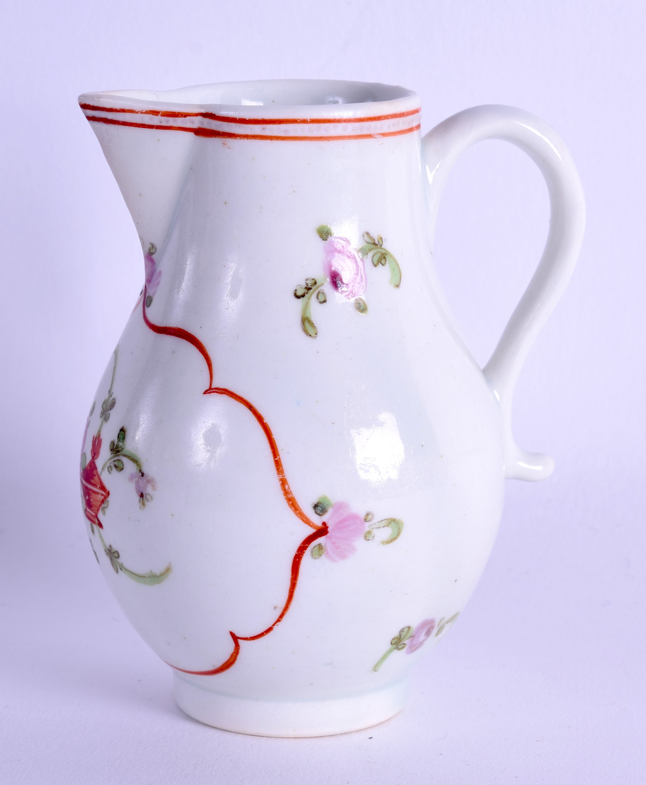 18th c. Lowestoft sparrow beak jug painted with a red line cartouche painted with a flower and