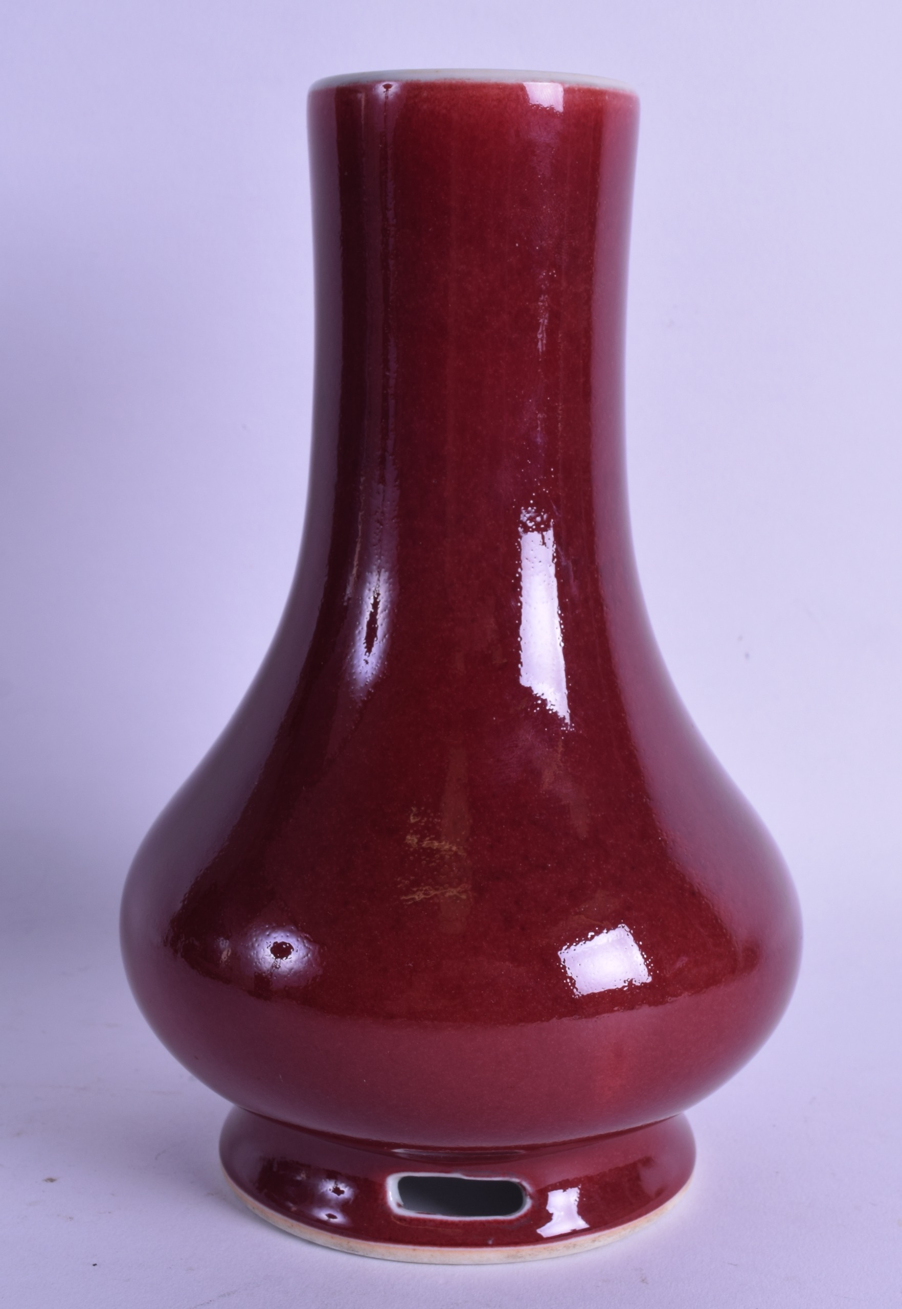 A CHINESE SANG DU BOEUF BALUSTER VASE with open work foot. 21.5 cm high.