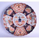 AN EARLY 19TH CENTURY JAPANESE IMARI SCALLOPED DISH painted with landscapes and birds. 30 cm wide.