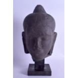 A LOUVRE MUSEUM COPY OF A BUDDHISTIC HEAD upon a marble plinth. Head 23 cm high.