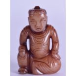 A SMALL CHINESE CARVED RUSSET JADE FIOGURE OF A SEATED MALE modelled in robes. 5.75 cm high.