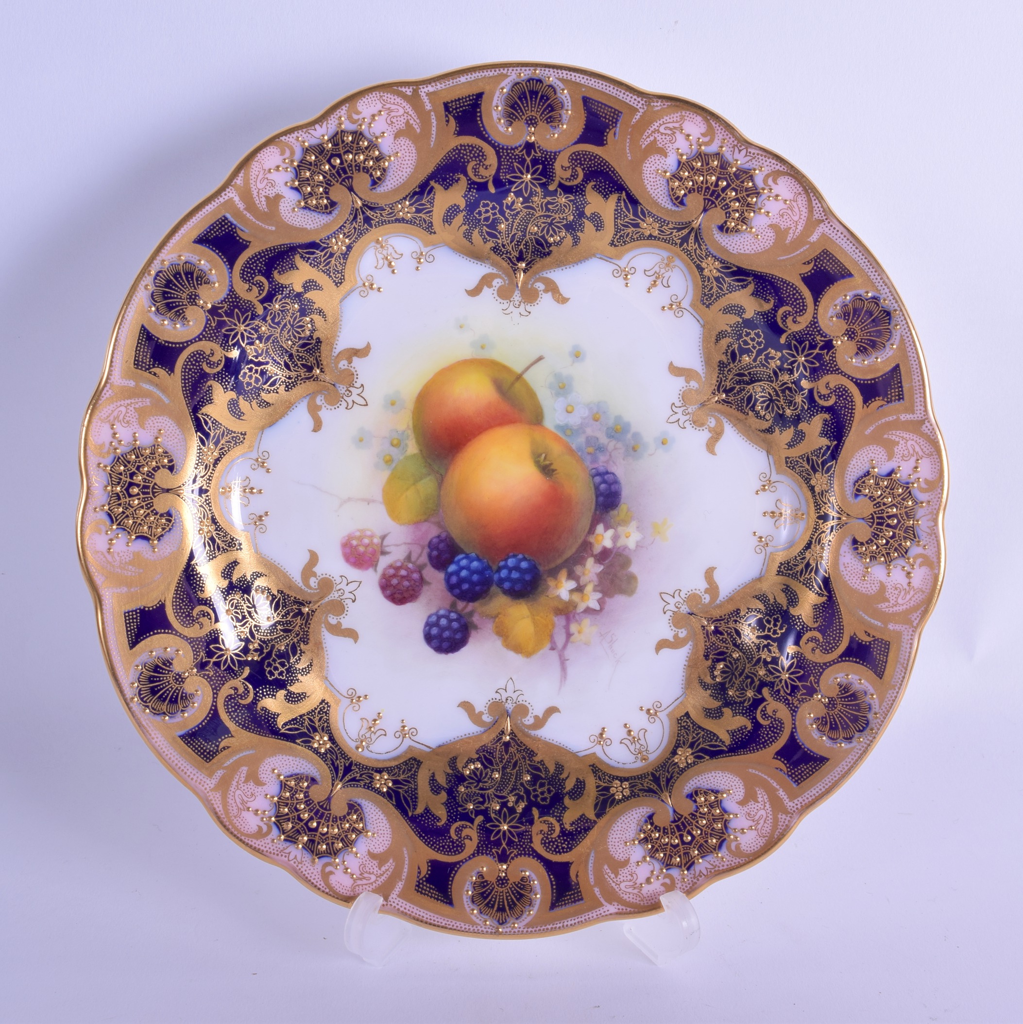 Early 20th c. Royal Worcester plate painted with fruit under a blue and gilt border by Albert Shuck,