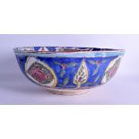 A LARGE EARLY 20TH CENTURY PERSIAN POTTERY BOWL painted with fish and motifs. 31 cm diameter.