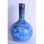 AN EARLY 20TH CENTURY MIDDLE EASTERN SAFAVID FAIENCE BULBOUS VASE painted with blue flowers and