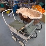 A VINTAGE DOLL'S PRAM, together with another containing a porcelain doll. Largest 74 cm wide.