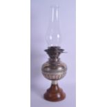 AN UNUSUAL EDWARDIAN SILVER OIL LAMP with turned wood base and engraved floral banding. London 1904.