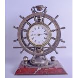 A GOOD ANTIQUE INDUSTRIAL DOUBLE SHIPS WHEEL CLOCK with ratchet winding mechanism, upon a canted red