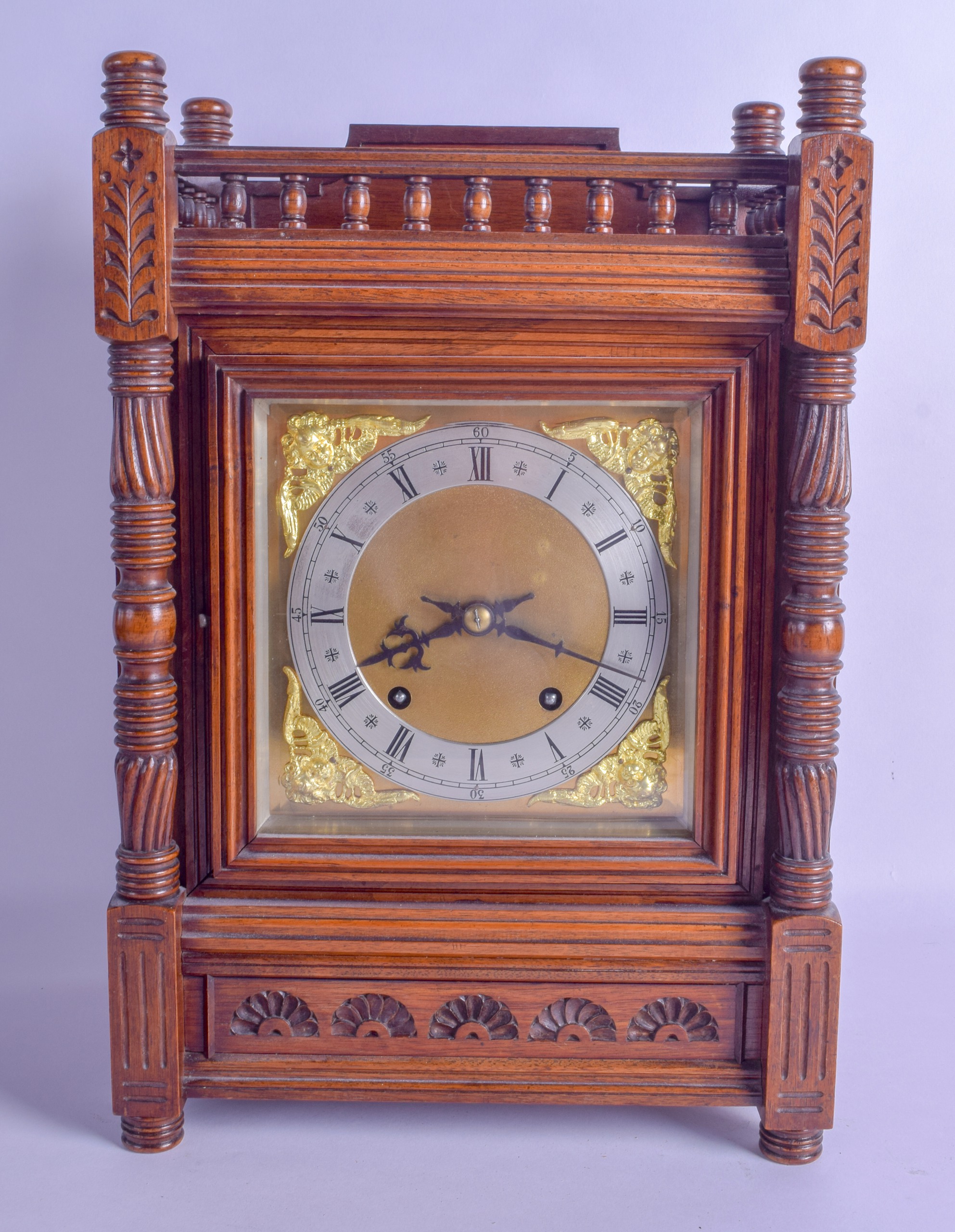 A LATE 19TH CENTURY CARVED OAK MANTEL CLOCK with columns supports and carved floral roundels. 40