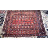 AN EARLY 20TH CENTURY RED GROUND RUG, decorated with motifs. 150 cm x 108 cm.