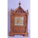 A LATE 19TH CENTURY GOTHIC REVIVAL CARVED OAK MANTEL CLOCK of architectural form, with brass mounted