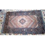 A SMALL PERSIAN RUG, dcorated with geometric symbols and motifs. 126 cm x 74 cm.