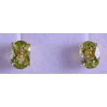 A PAIR OF 9CT GOLD AND PERIDOT EARRINGS.