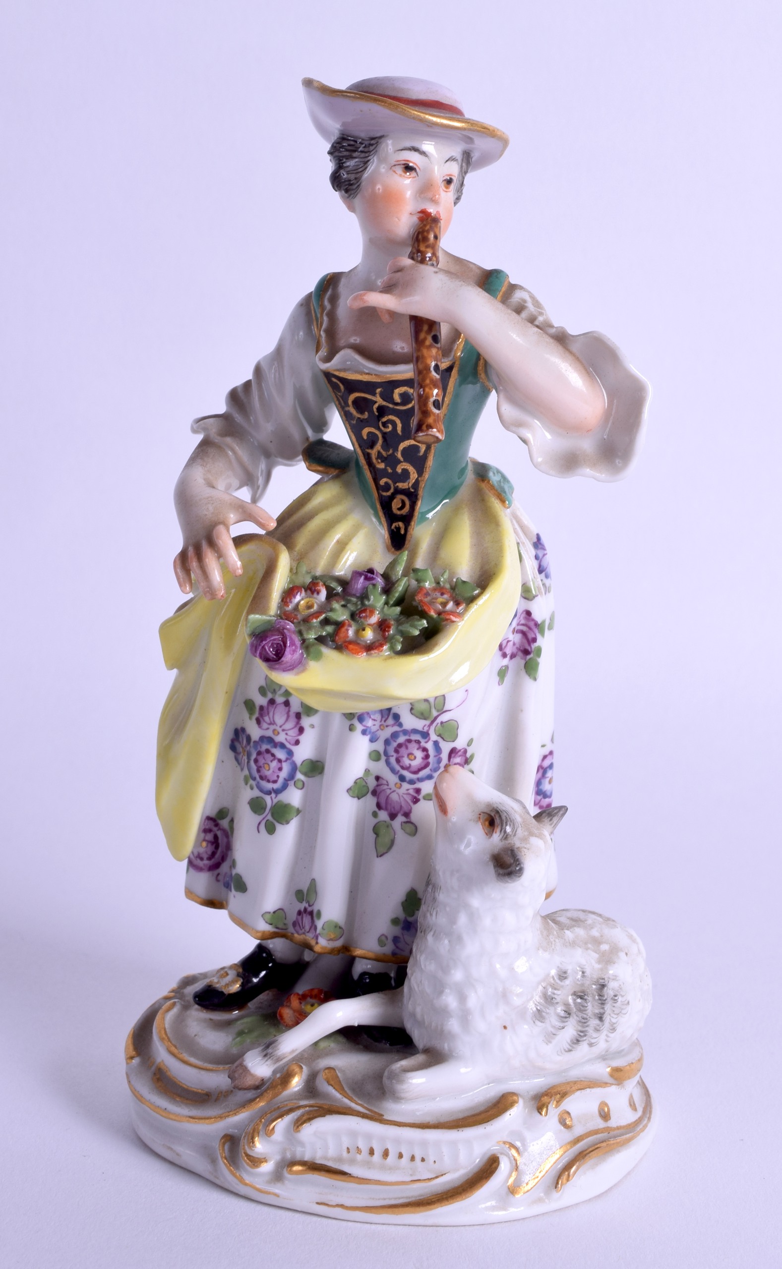 20th c. Meissen figure of a girl playing a flute and standing beside a lamb, blue crossed swords