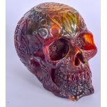 AN UNUSUAL AMBER TYPE SKULL, decorated with symbols. 14 cm high.