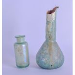 AN EARLY EUROPEAN GLASS MEDICINE JAR possibly Roman, together with another vase or water dropper.