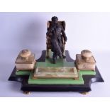 A LARGE AND UNUSUAL VICTORIAN ONYX MARBLE AND SPELTER DESK STAND modelled as a seated male holding a