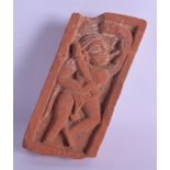 AN ANTIQUE CARVED INDIAN RED STONE BRICK SCULPTURE depicting a figure blowing a horn. 11 cm x 23