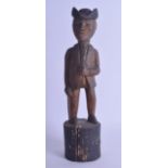 AN UNUSUAL EARLY 20TH CENTURY CARVED FOLK ART FIGURE OF A MALE modelled wearing a Bicorn hat, upon a