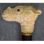 AN EARLY 20TH CENTURY CARVED WALKING STICK, the handle in the form of a bulldog head. 100 cm long.