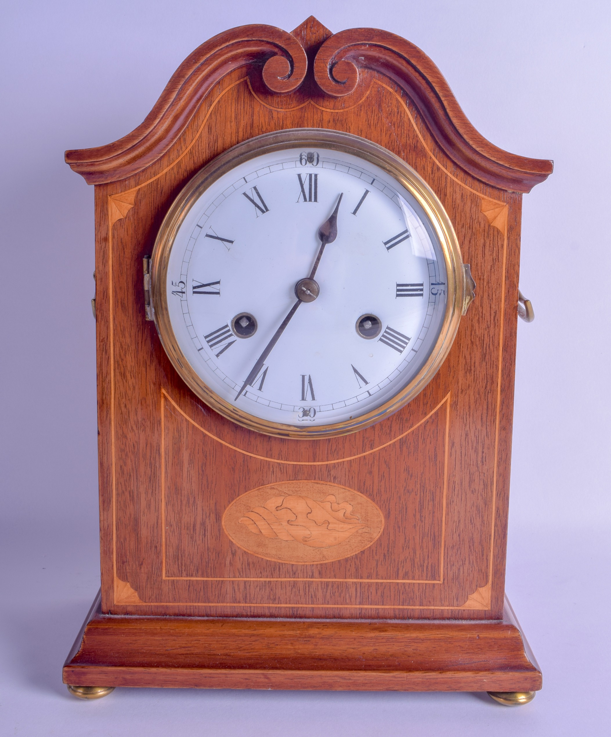 AN EDWARDIAN MAHOGANY MANTEL CLOCK with large circular enamelled dial, painted with black