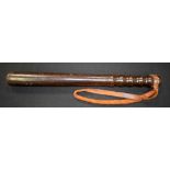 AN EARLY 20TH CENTURY WOODEN TRUNCHEON, with leather strap. 39 cm long.