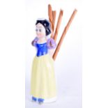 A VINTAGE PORCELAIN TAPERSTICK HOLDER, in the form of Disneys Snow White. 15 cm high.