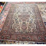 AN EARLY 20TH CENTURY BEIGE GROUND PERSIAN RUG, decorated with extensive foliage. 206 cm x 140 cm.