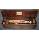 AN ANTIQUE CROCQUET SET, contained within a wooden box.