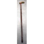 A CARVED EARLY 20TH CENTURY WALKING STICK, with rhinoceros horn handle. 87 cm long.