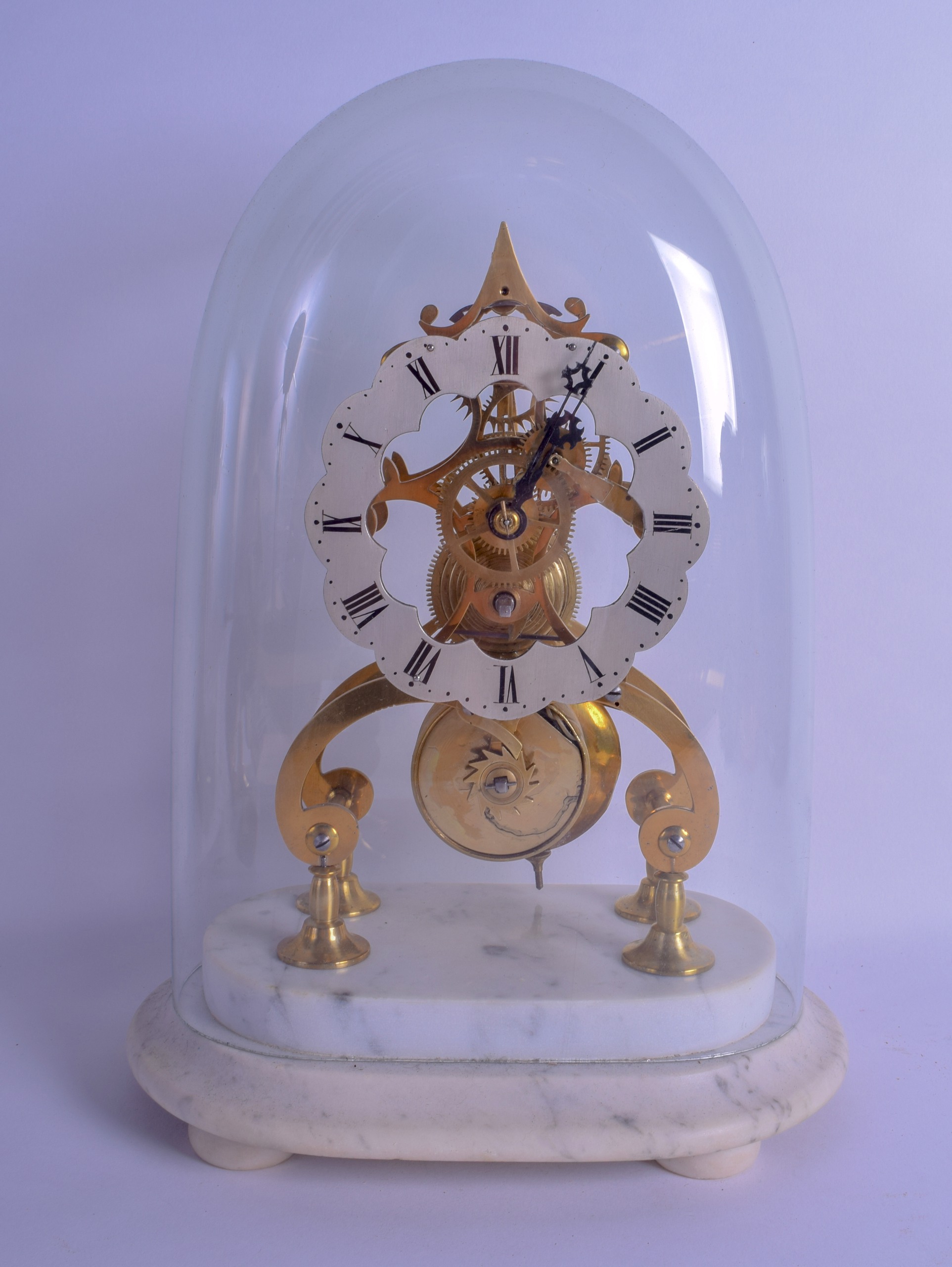 A FRENCH GLASS CASED BRASS SKELETON CLOCK with petal shaped silvered dial. Clock 23 cm x 12 cm.